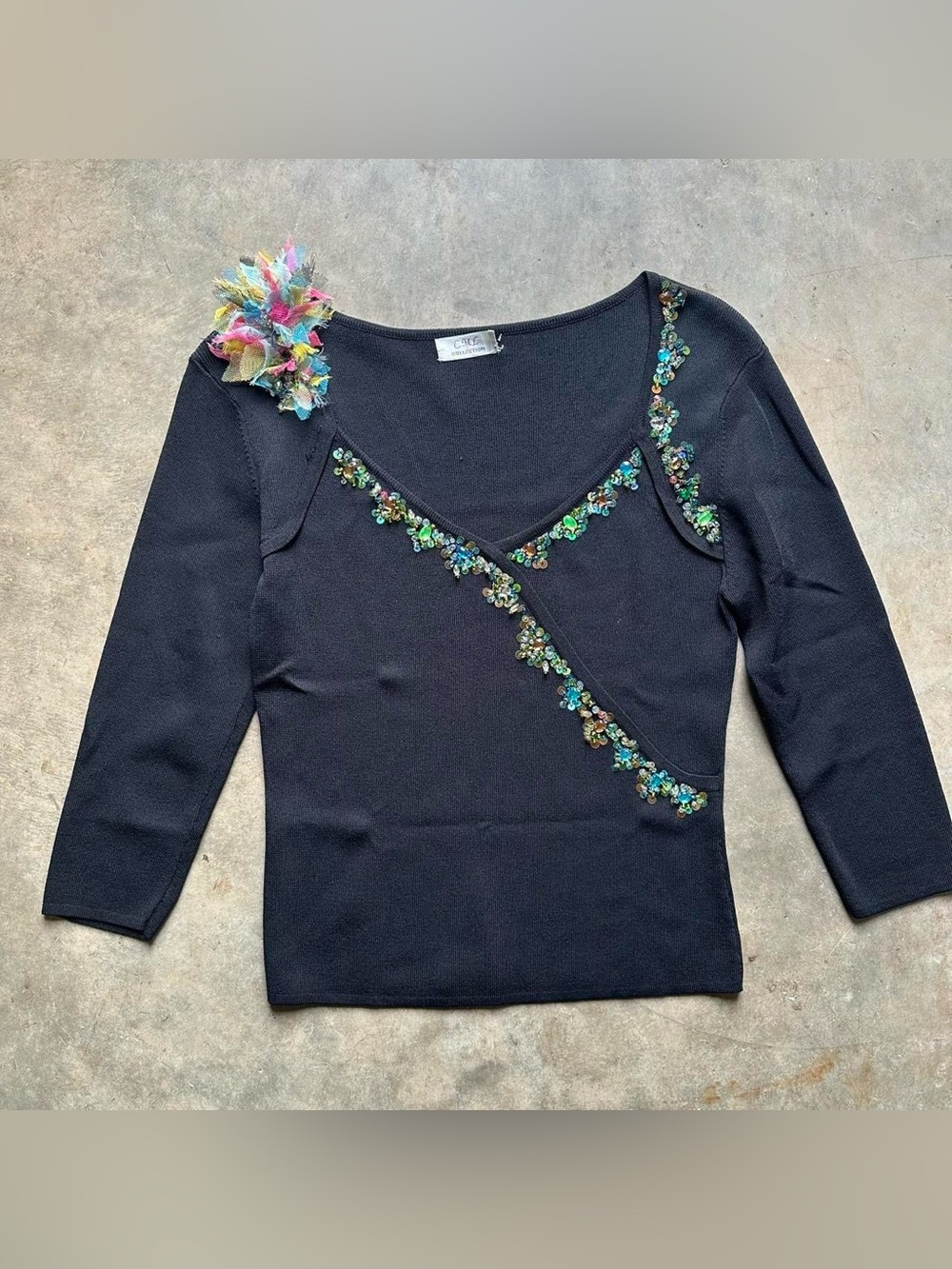 Black beaded long sleeve top with flower detail